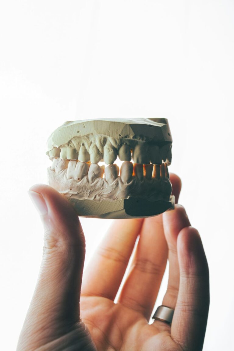 A young child showing a chipped front tooth with a concerned parent nearby in a home setting.